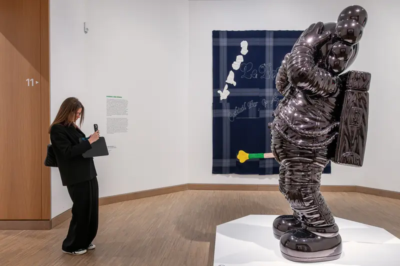 Visitor Photographs KAWS Sculpture at Albertina Modern Vienna Exhibition