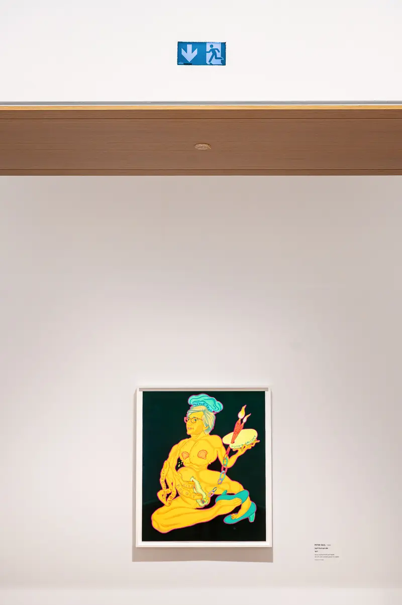 Yellow figure artwork with blue directional signage at Albertina Modern exhibition