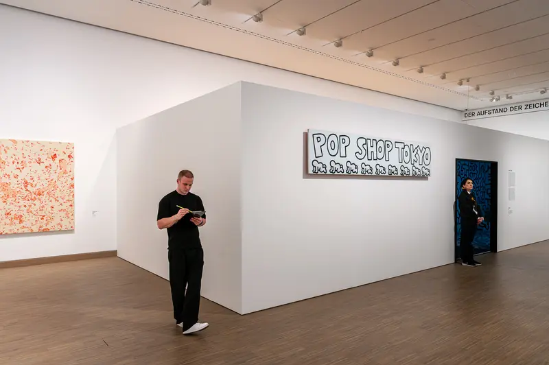 Visitor Views Keith Haring Pop Shop Tokyo Installation at Albertina Modern Vienna
