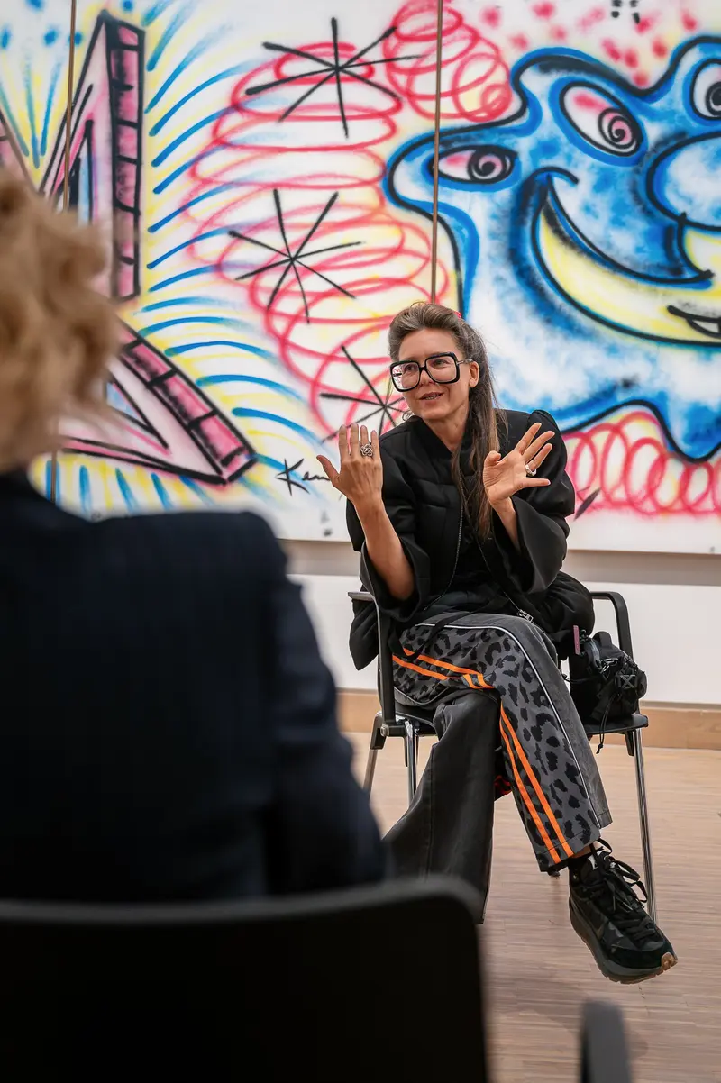 Angela Stief speaks during press tour of KAWS. Art & Comix exhibition