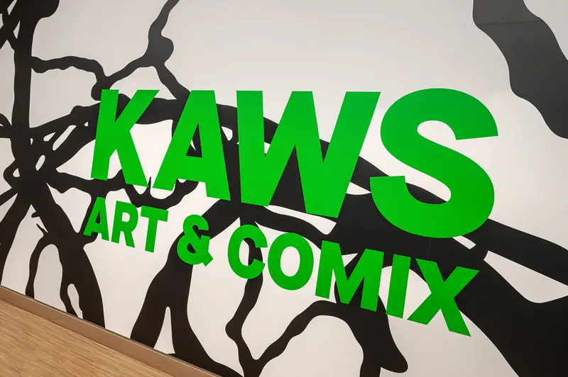 KAWS "Art & Comix" exhibition title wall at Albertina Modern, Vienna