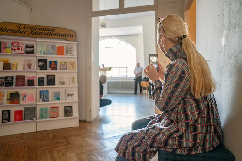 Visitor documenting exhibition at VBKÖ Archive re-opening, Vienna 2026