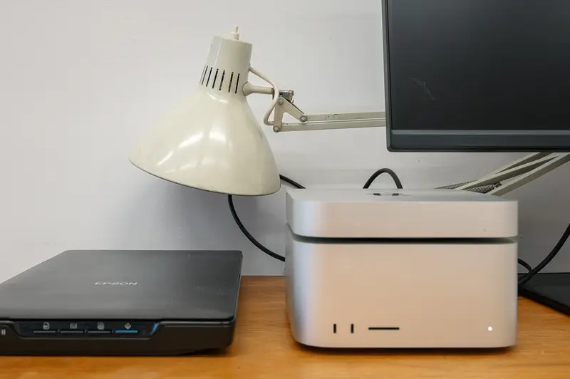 Workspace Setup with Desk Lamp, Computer Equipment, and Monitor Display