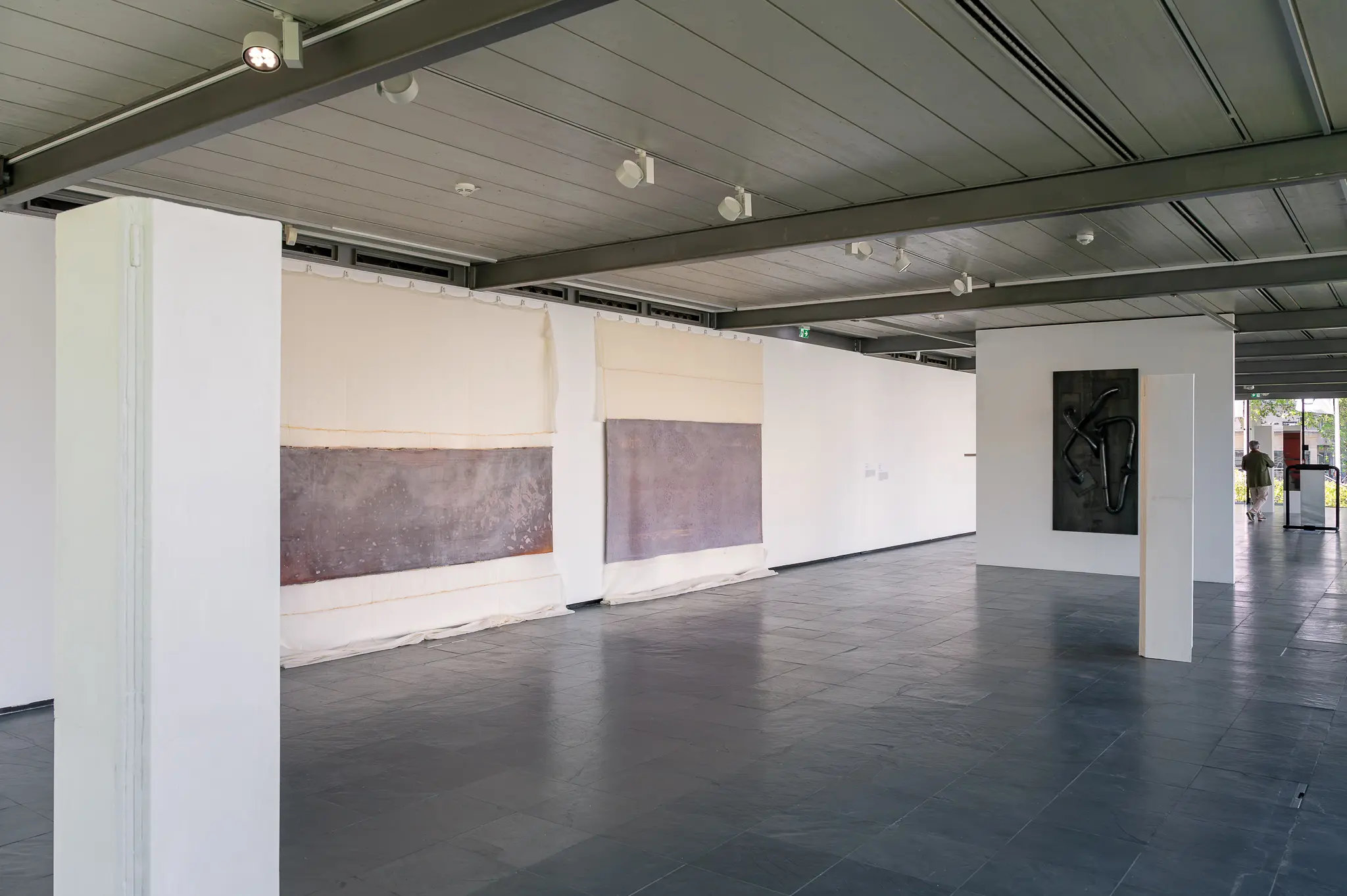 Contemporary Art Gallery Interior with Abstract Paintings and Structural Columns