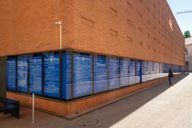 Brick Building with Blue Display Panels and Pedestrian Walkway