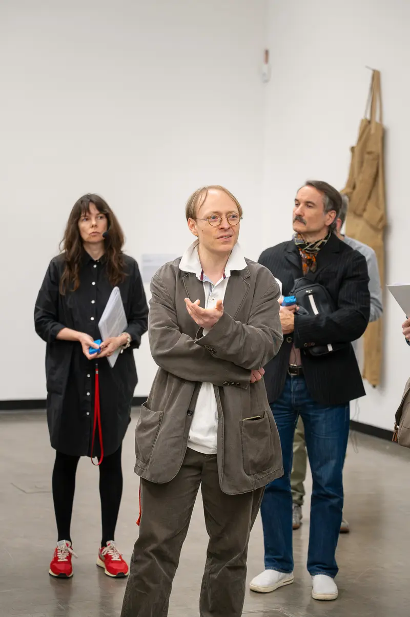 Three Speakers in Gallery Setting During Contemporary Art Event