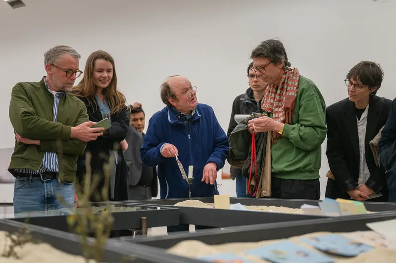 Group Discussion Around Design Materials at Workshop Event