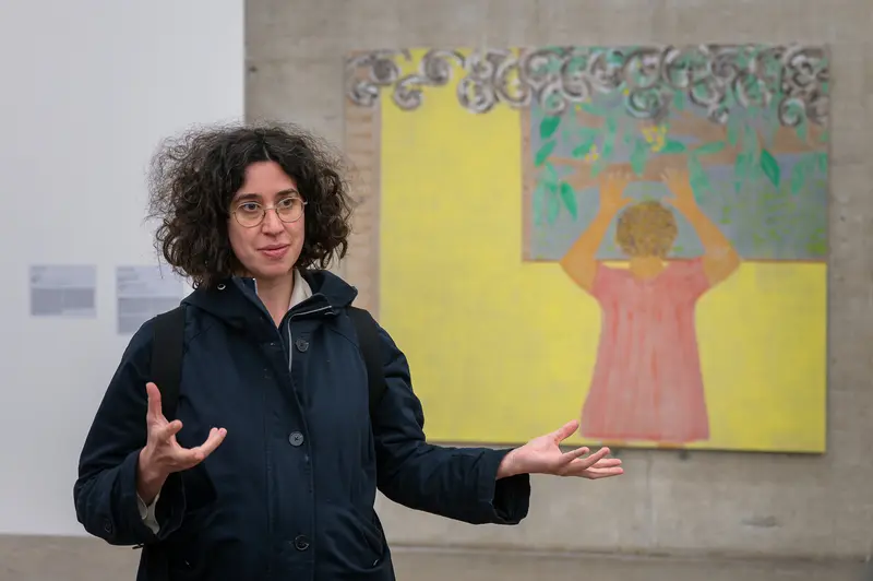 Art Educator Presenting Contemporary Artwork in Gallery Space