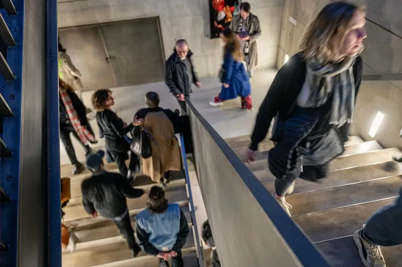 Exhibition Attendees on Concrete Staircase at Kunsthalle Wien, April 2026