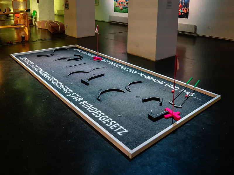 Interactive Design Installation with Typographic Floor Display and Colored Props