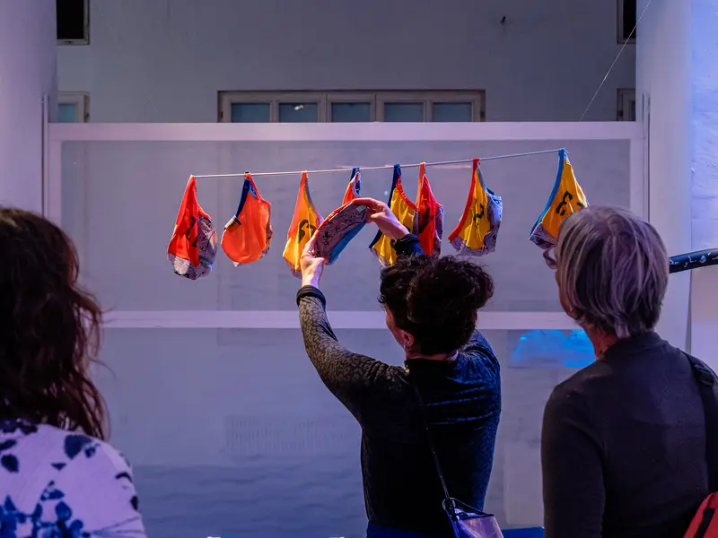 Gallery Visitors Engaging with Suspended Textile Installation Art