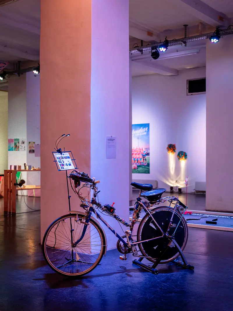 Purple-Lit Bicycle Installation in Contemporary Art Gallery