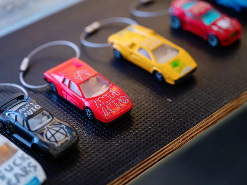 Miniature Car Keychains Collection on Textured Surface