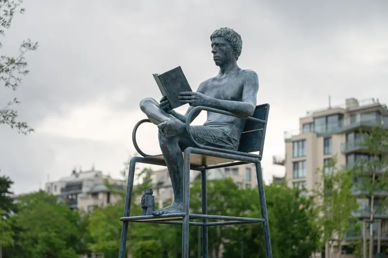 Bronze Figure Reading in Bank Austria Park, Vienna-Floridsdorf