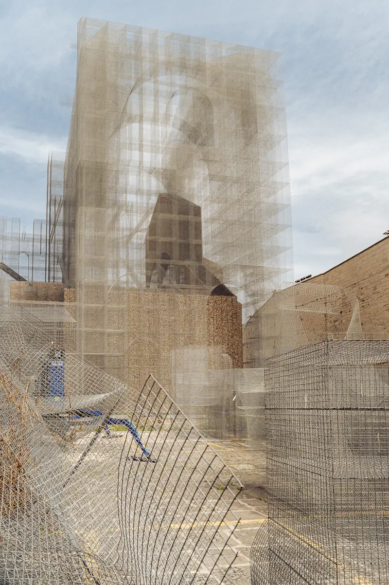 Architectural Renovation with Protective Mesh Screening and Exposed Structure