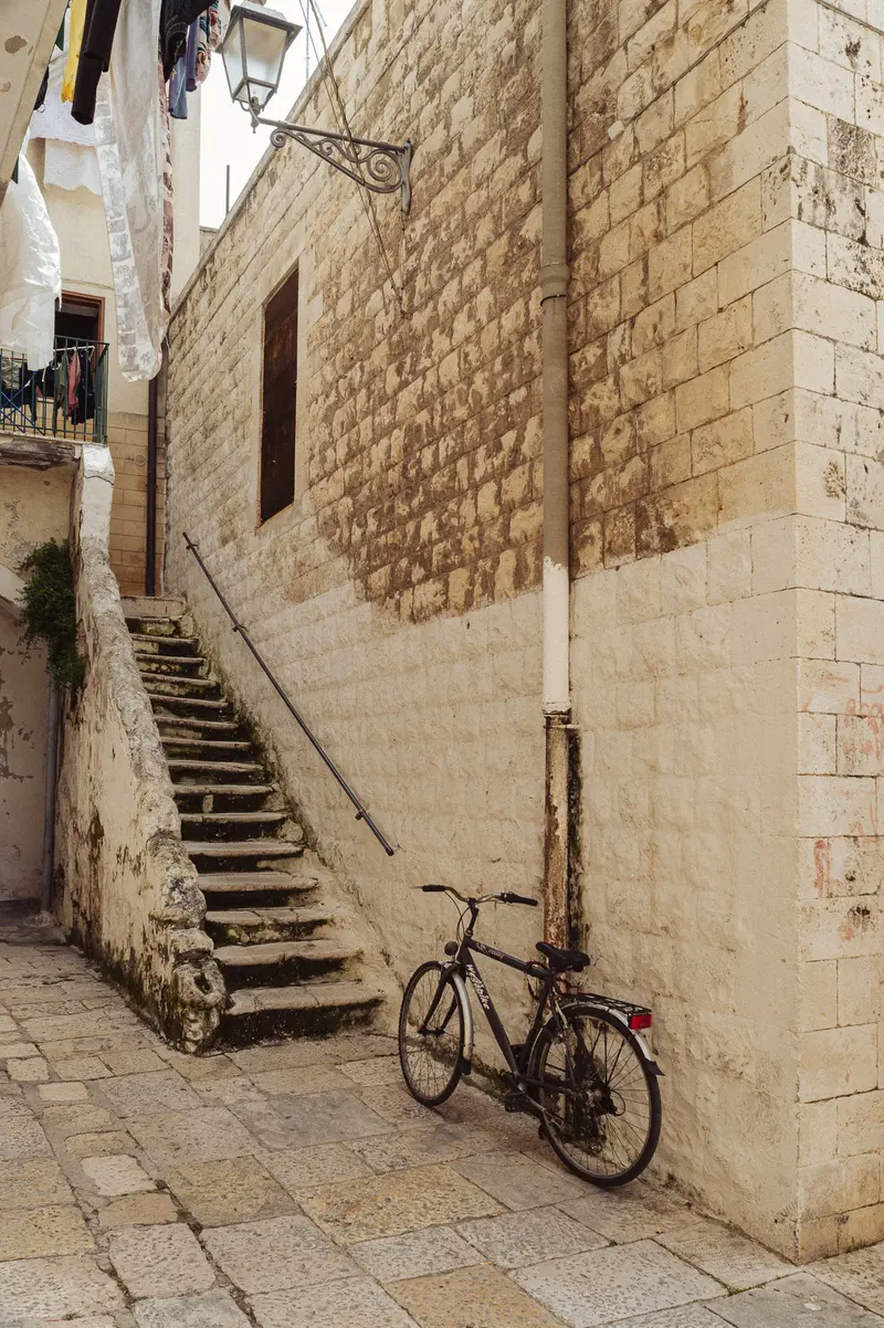 Bicycle Parked Against Stone Walls in Historic Mediterranean Alleyway