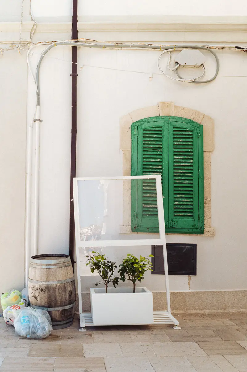 Rustic Mediterranean Courtyard with Green Shutters and Garden Accents