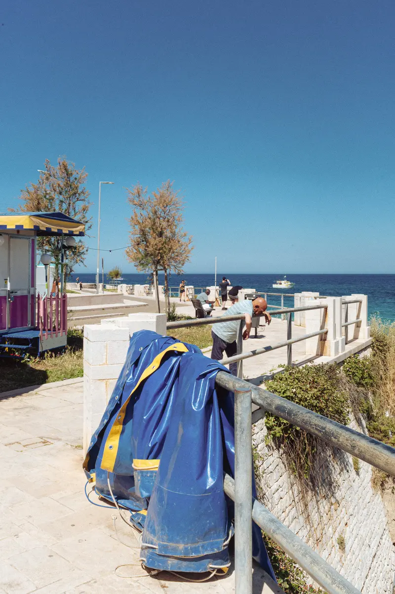 Blue Backpack on Waterfront Boardwalk with Coastal Infrastructure