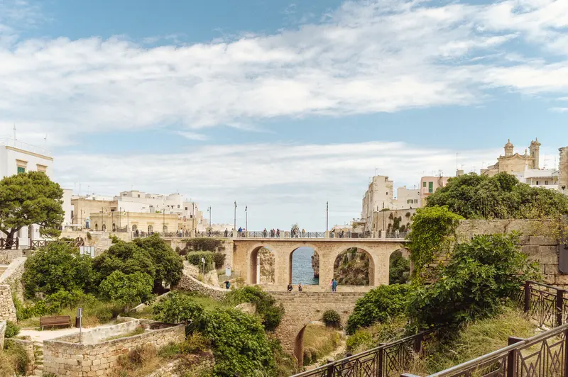 Ancient Stone Bridge with Arches Spanning Valley in Historic Mediterranean Town