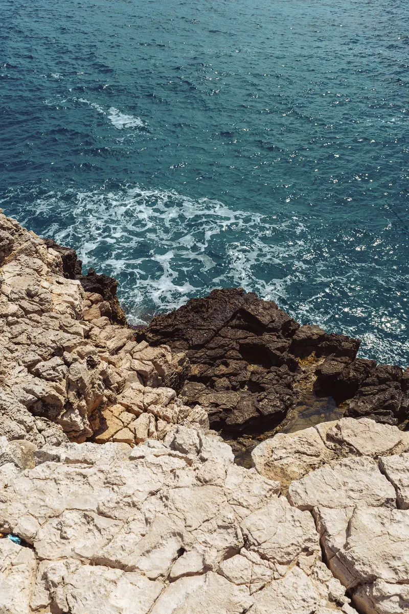 Rocky Coastal Cliff Overlooking Turquoise Mediterranean Waters