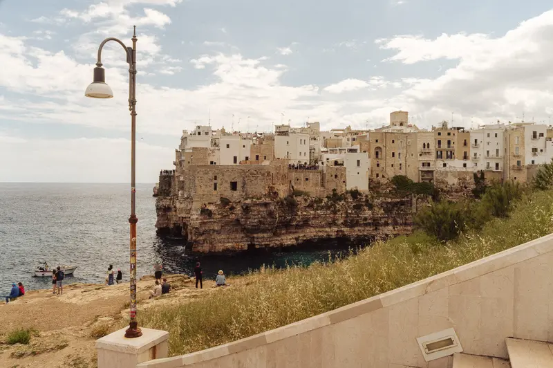 Polignano a Mare Clifftop Town with Beach and Lamp Post