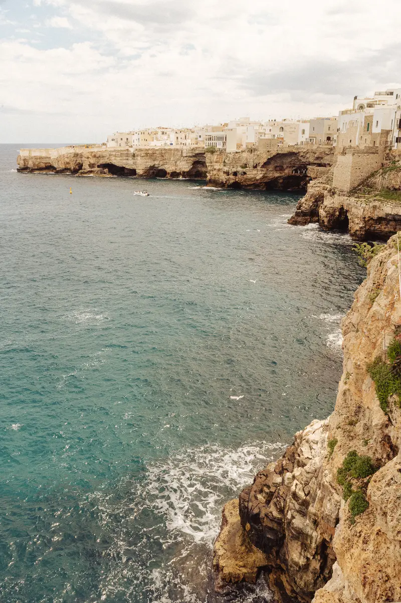 Clifftop Coastal Town with Whitewashed Buildings and Turquoise Waters