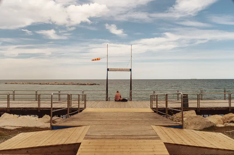Wooden Pier Structure with Diving Platform Overlooking Calm Sea