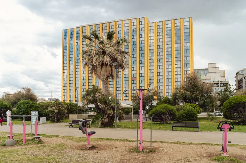 Urban Park with Outdoor Fitness Equipment and High-Rise Residential Building