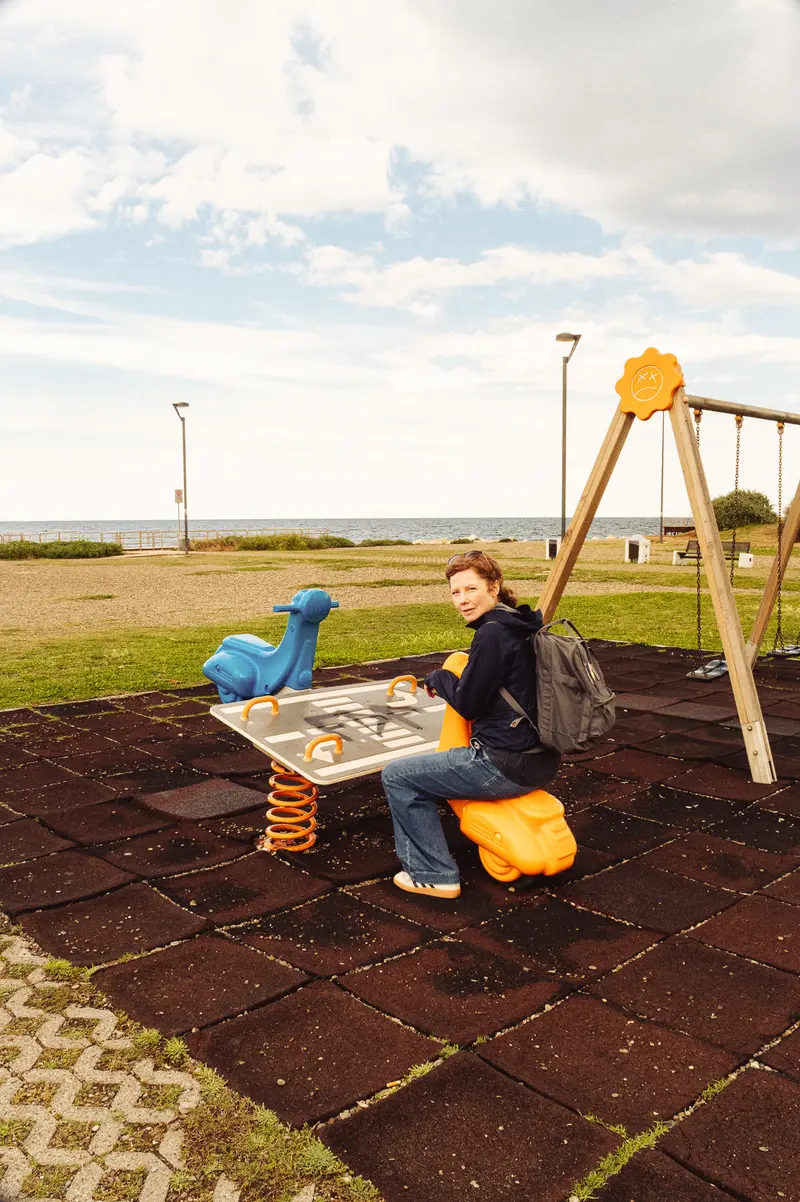 Children Playing in Rural Playground with Yellow Equipment