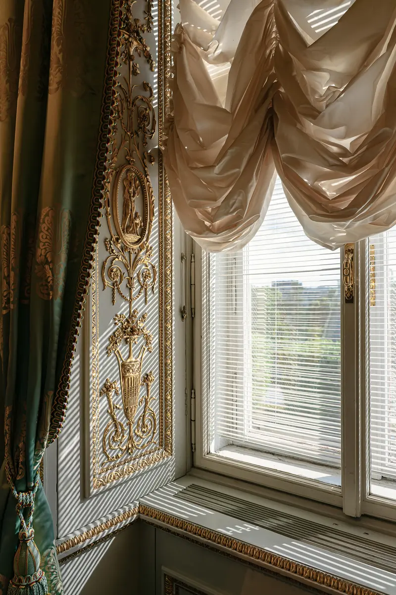 Ornate Window with Draped Fabric and Urban View