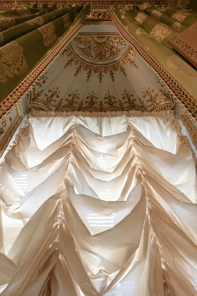 Ornate Ceiling with Draped Fabric Installation and Decorative Molding