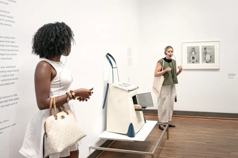 Gallery Visitors Viewing Framed Photographs in Contemporary Art Exhibition
