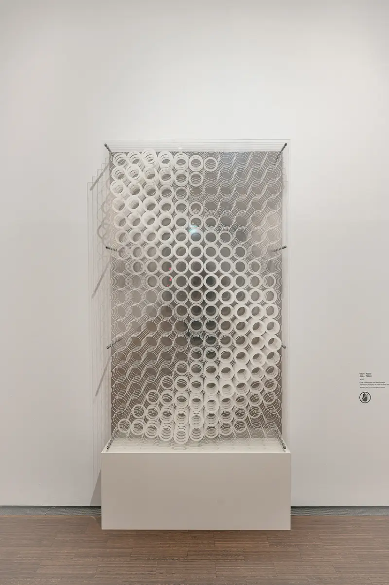 Translucent Perforated Panel Installation on White Plinth