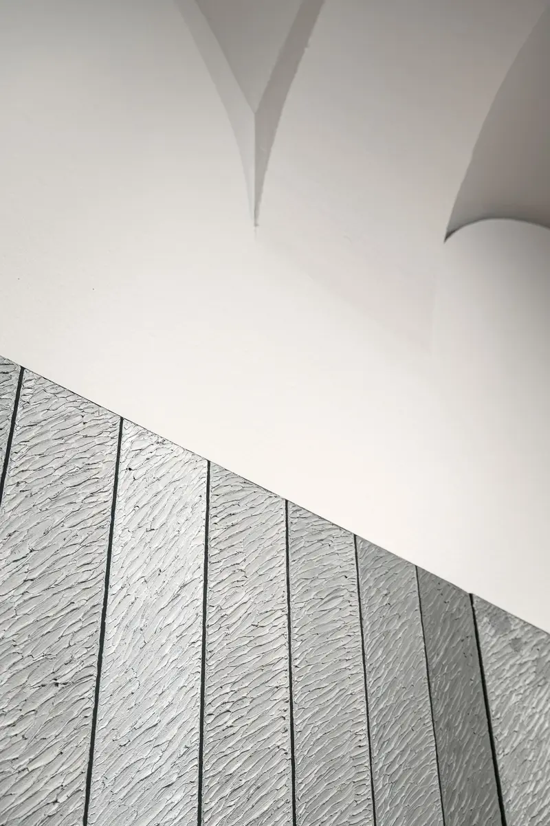 Minimalist Architectural Detail with Vertical Paneling and Curved Ceiling