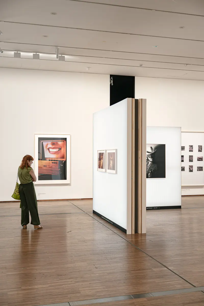 Visitor Viewing Contemporary Photography Exhibition in Modern Gallery Space