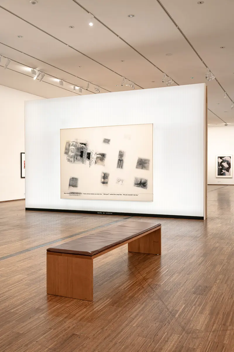 Gallery Exhibition Display with Wooden Bench and Framed Photographs