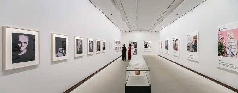 Modern Art Gallery Exhibition with Framed Photographs and Display Case