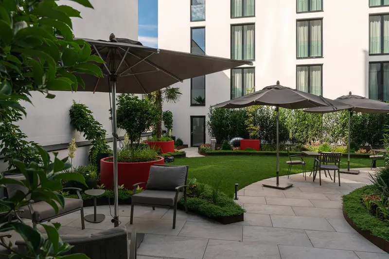 Hotel Chotek Vienna courtyard with umbrellas and seating at IgersWalk June 2026