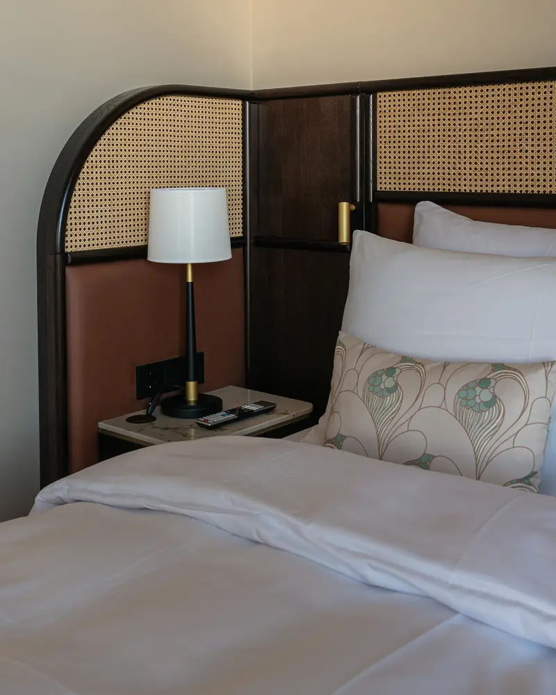 Modern Bedroom with Caned Headboard and Bedside Lamp