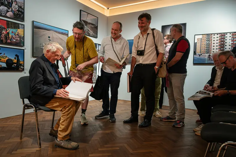 Sir Don McCullin Signs Books for Attendees at Leica Gallery Vienna