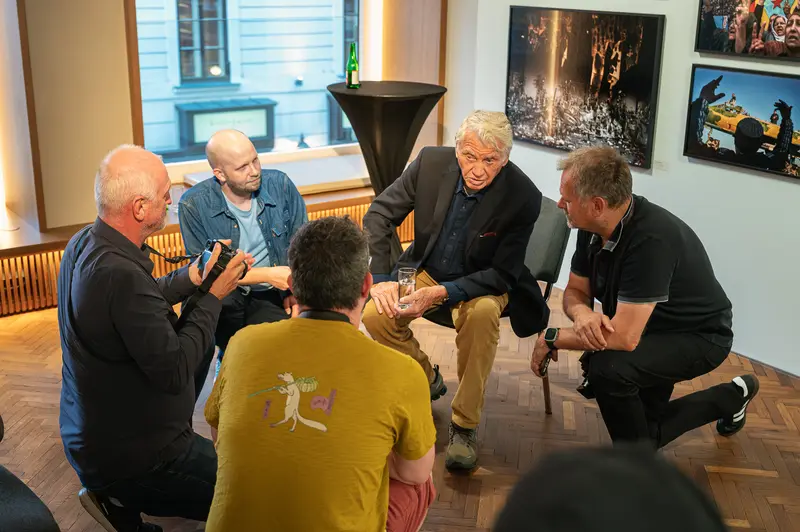Don McCullin Seated in Conversation with Visitors at Leica Gallery Vienna