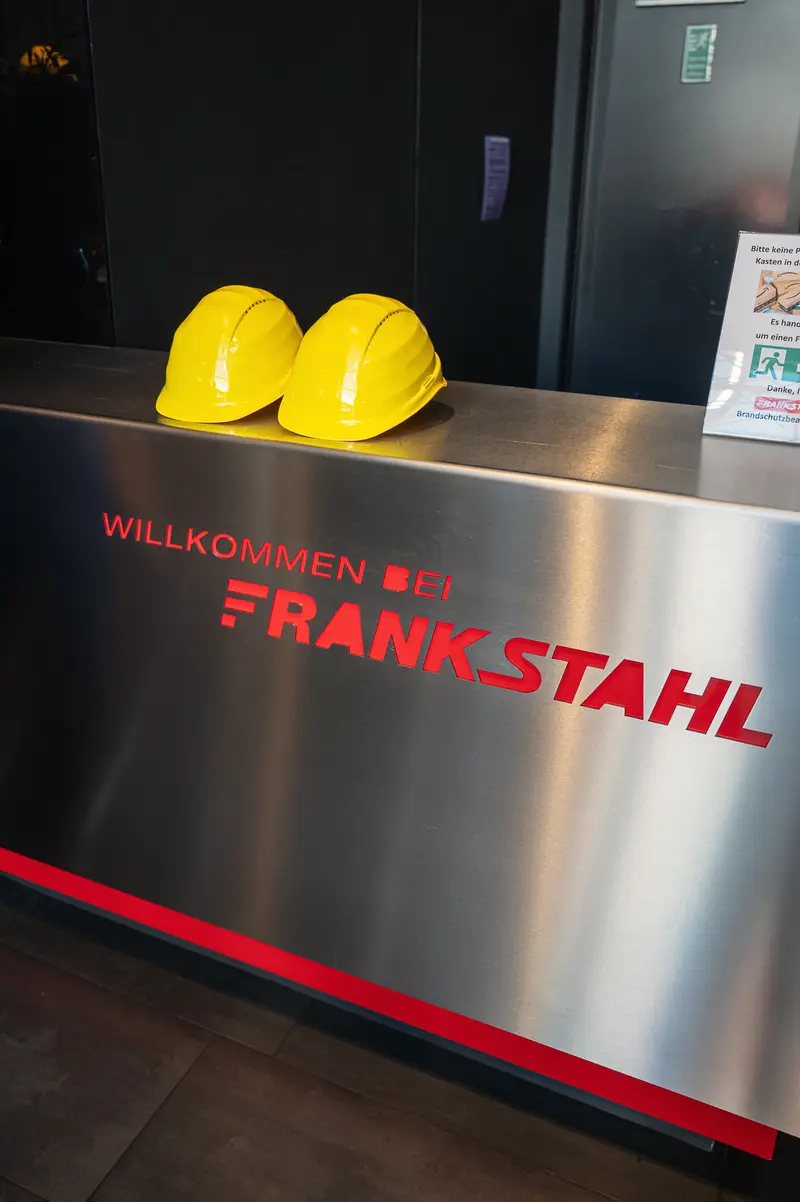 Frankstahl Reception Desk With Two Yellow Hard Hats