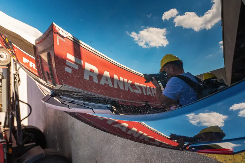 Frankstahl truck cab reflection with yellow hard hat visitor