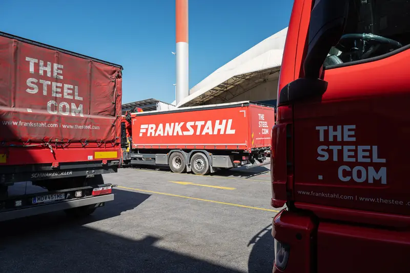 Frankstahl and thesteel.com branded delivery trucks in Guntramsdorf yard