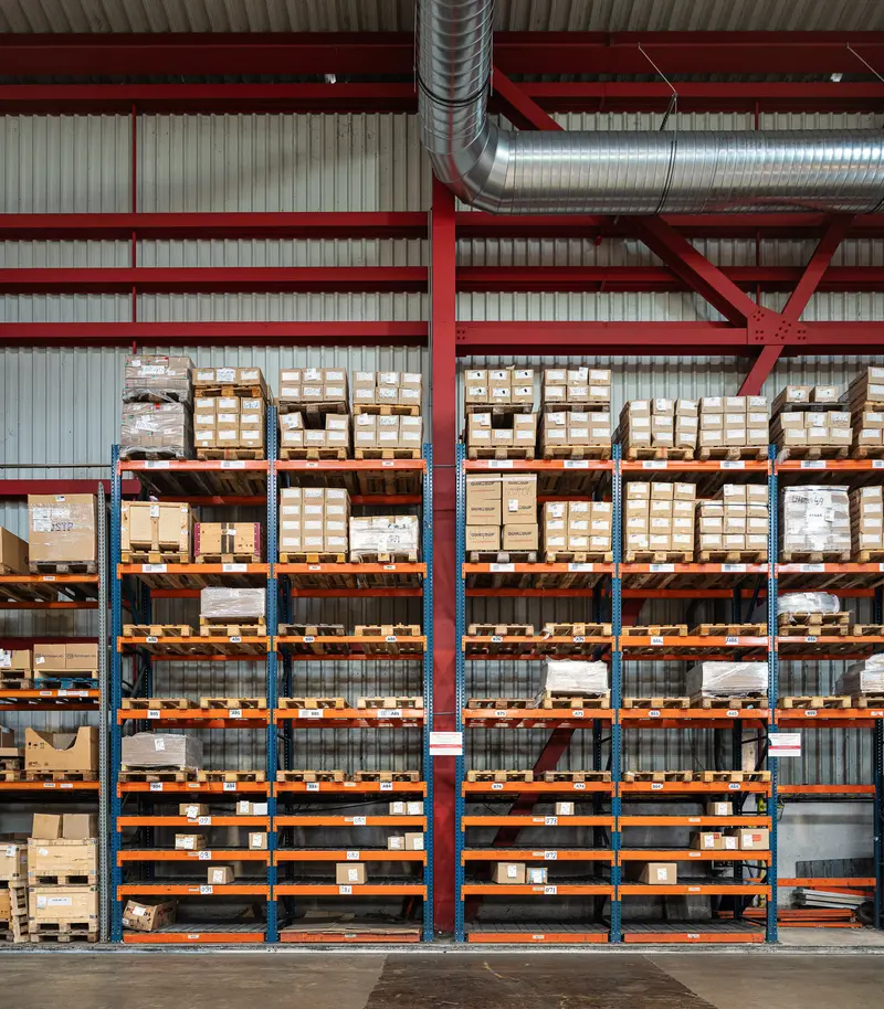 Pallet racking system filled with boxed fittings inside Frankstahl warehouse