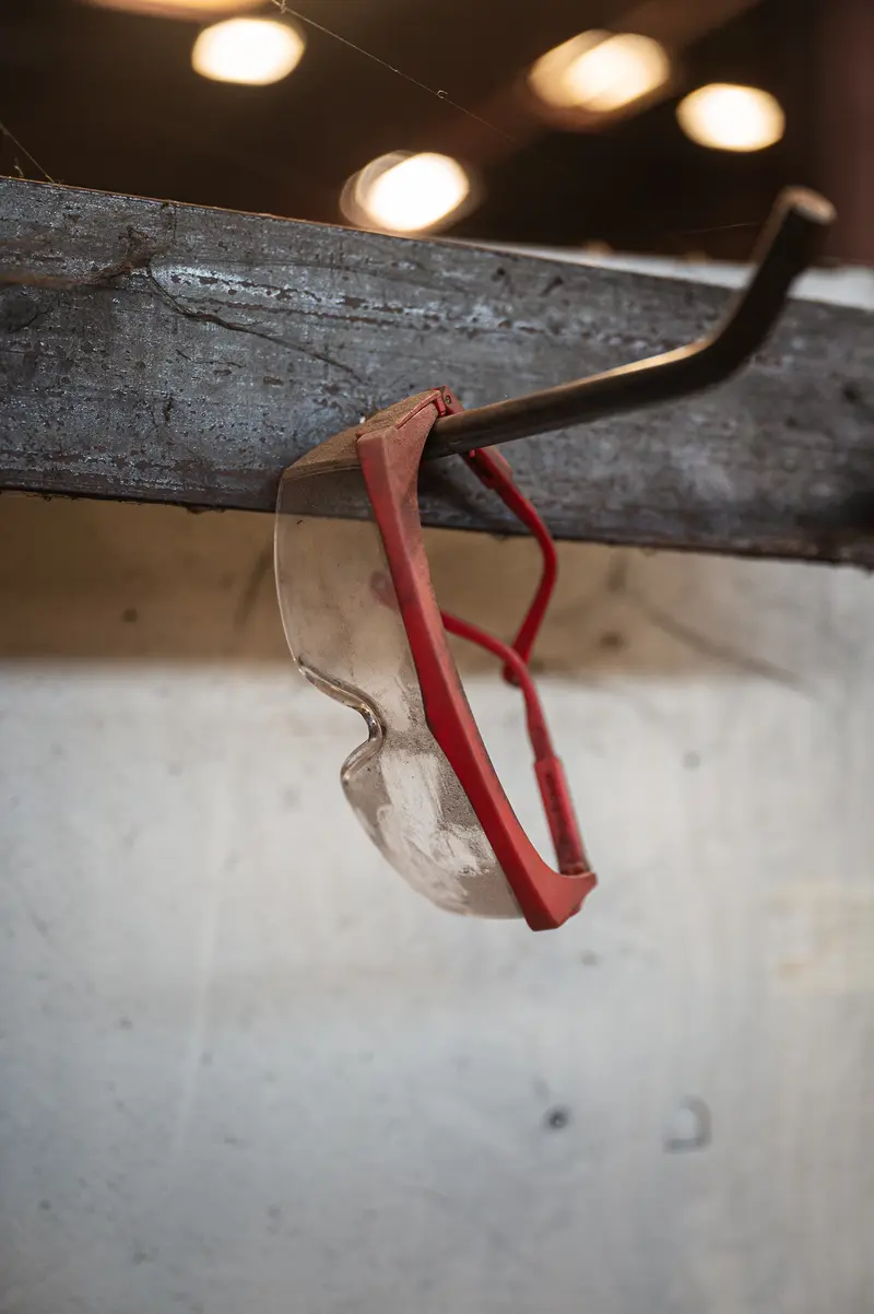 Red Safety Glasses Hanging on a Hook at Frankstahl Guntramsdorf