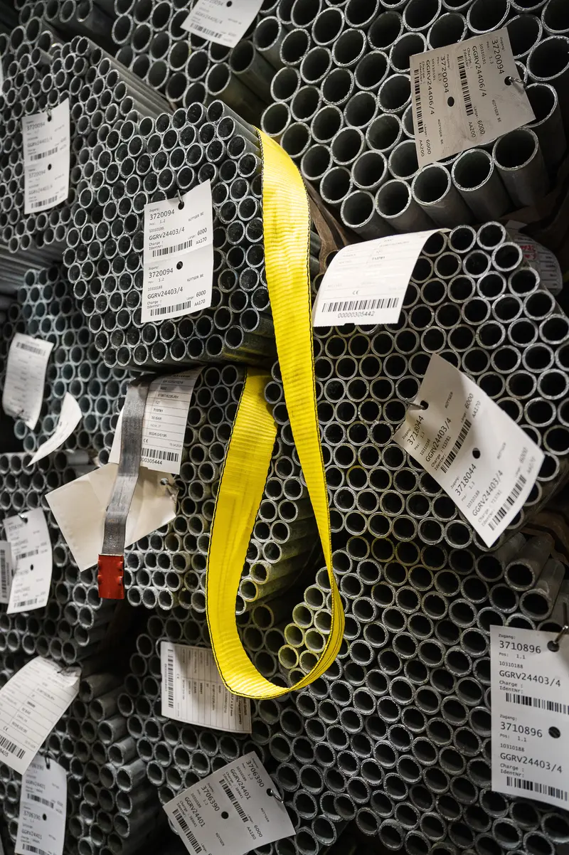 Tagged steel pipes bundled with yellow lifting strap at Frankstahl Guntramsdorf