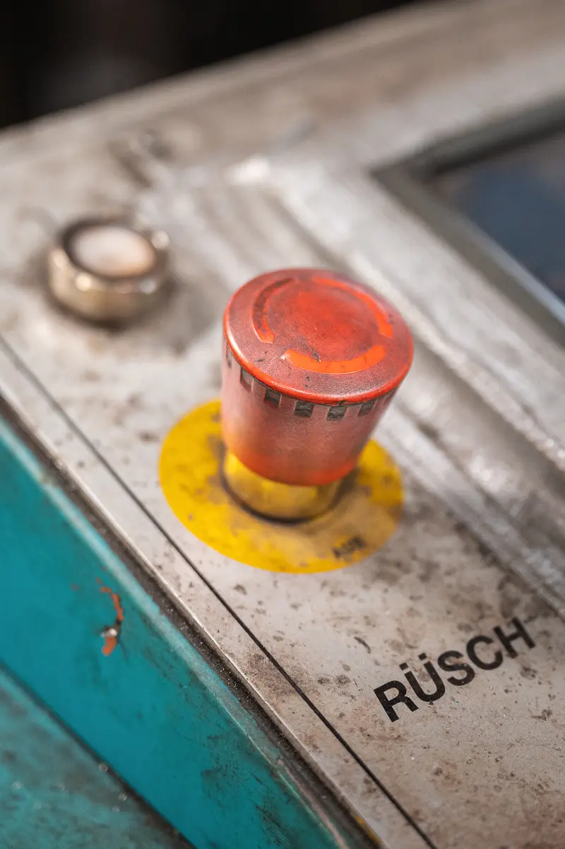 Red Emergency-Stop Button Labelled RÜSCH on Industrial Control Panel