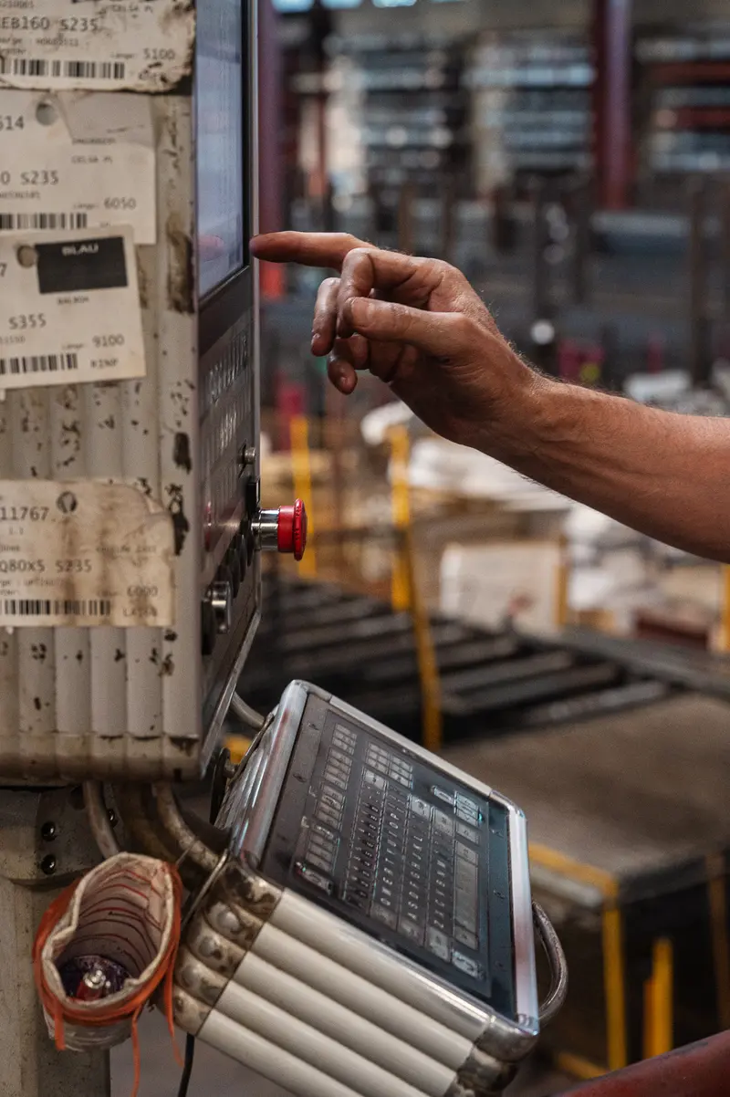 Worker Operating Control Terminal on Frankstahl Steel Warehouse Floor