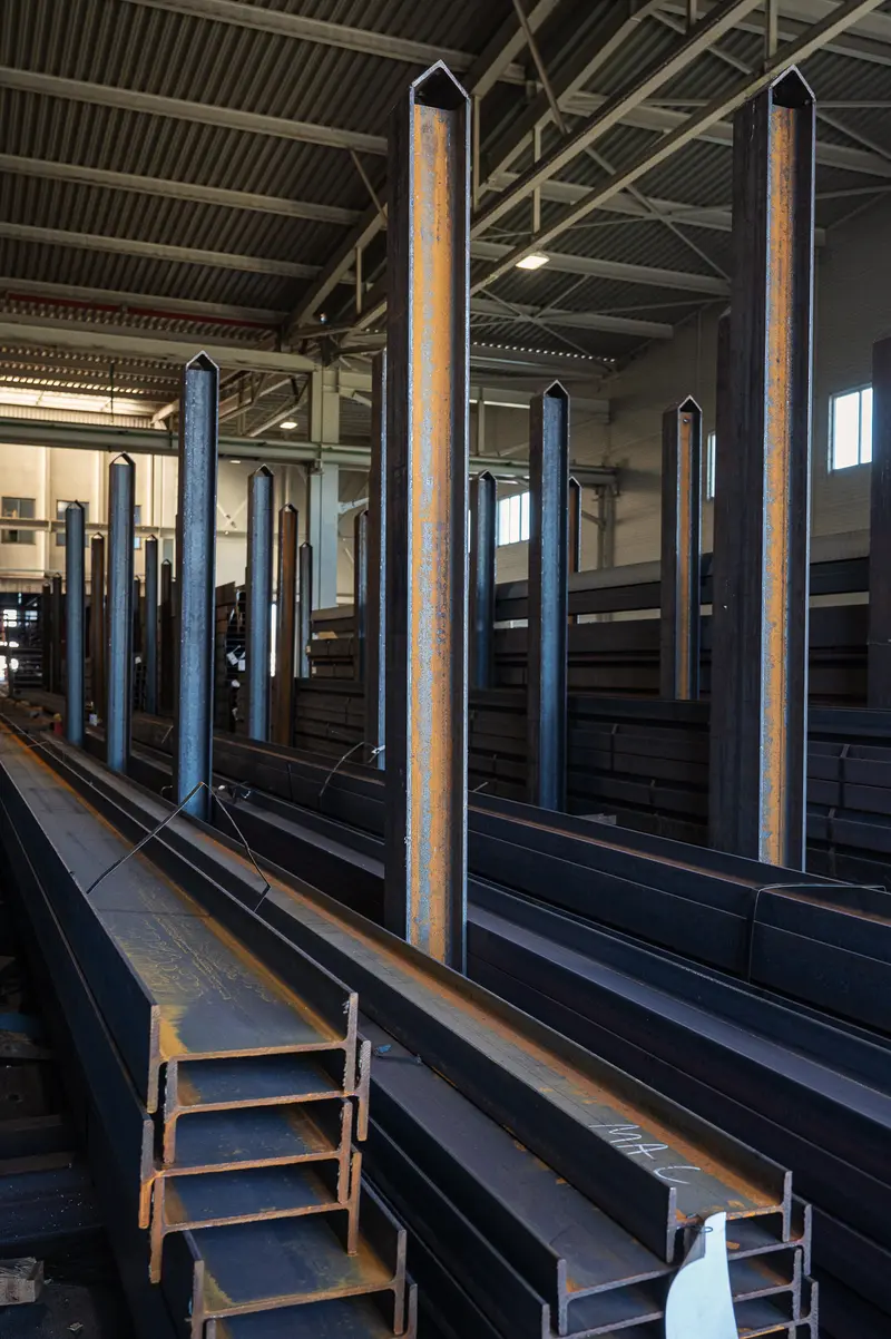Steel H-beams and vertical storage columns inside Frankstahl warehouse, Guntramsdorf